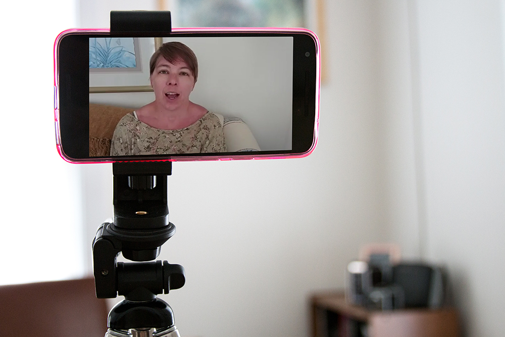 Facebook live using a smartphone and phone holder.